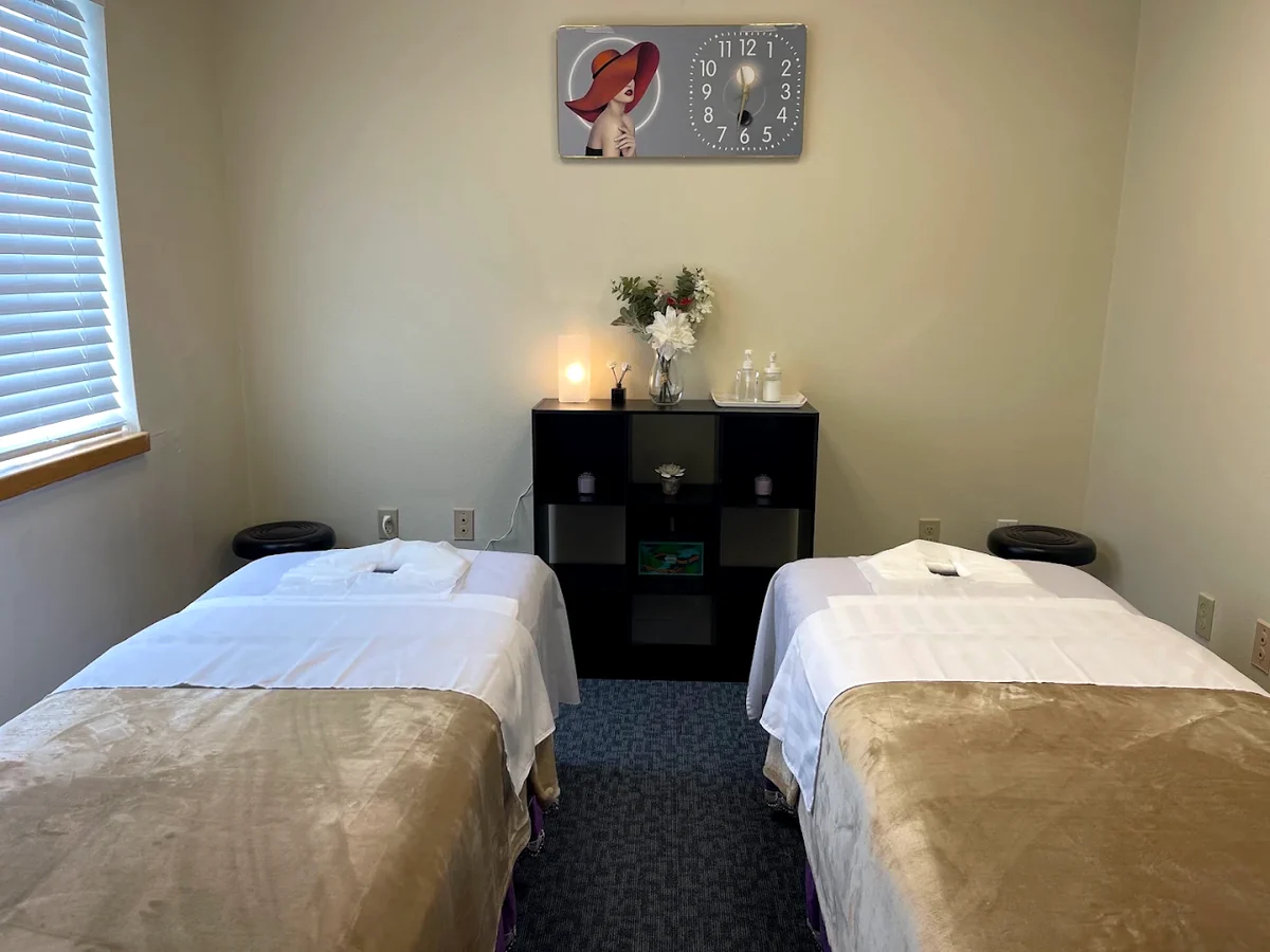 The couples room at West Valley Massage, two massage tables made up side by side in white linen